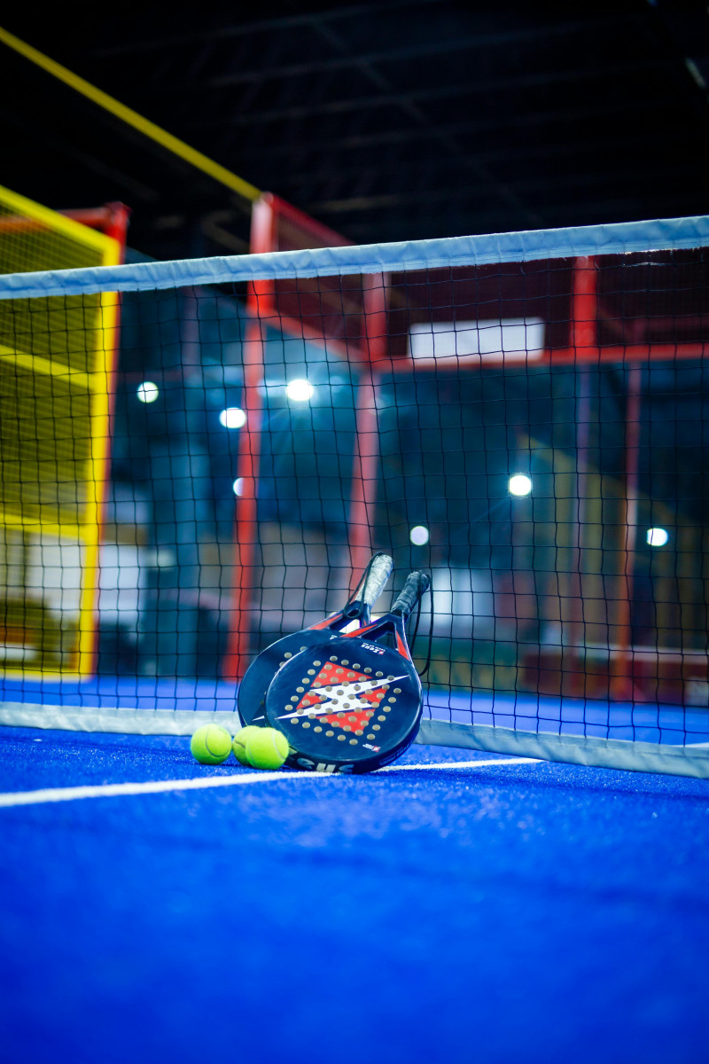 Foto de Critical Smith : https://www.pexels.com/es-es/foto/pista-de-padel-cubierta-vibrante-con-raqueta-y-pelotas-32897040/